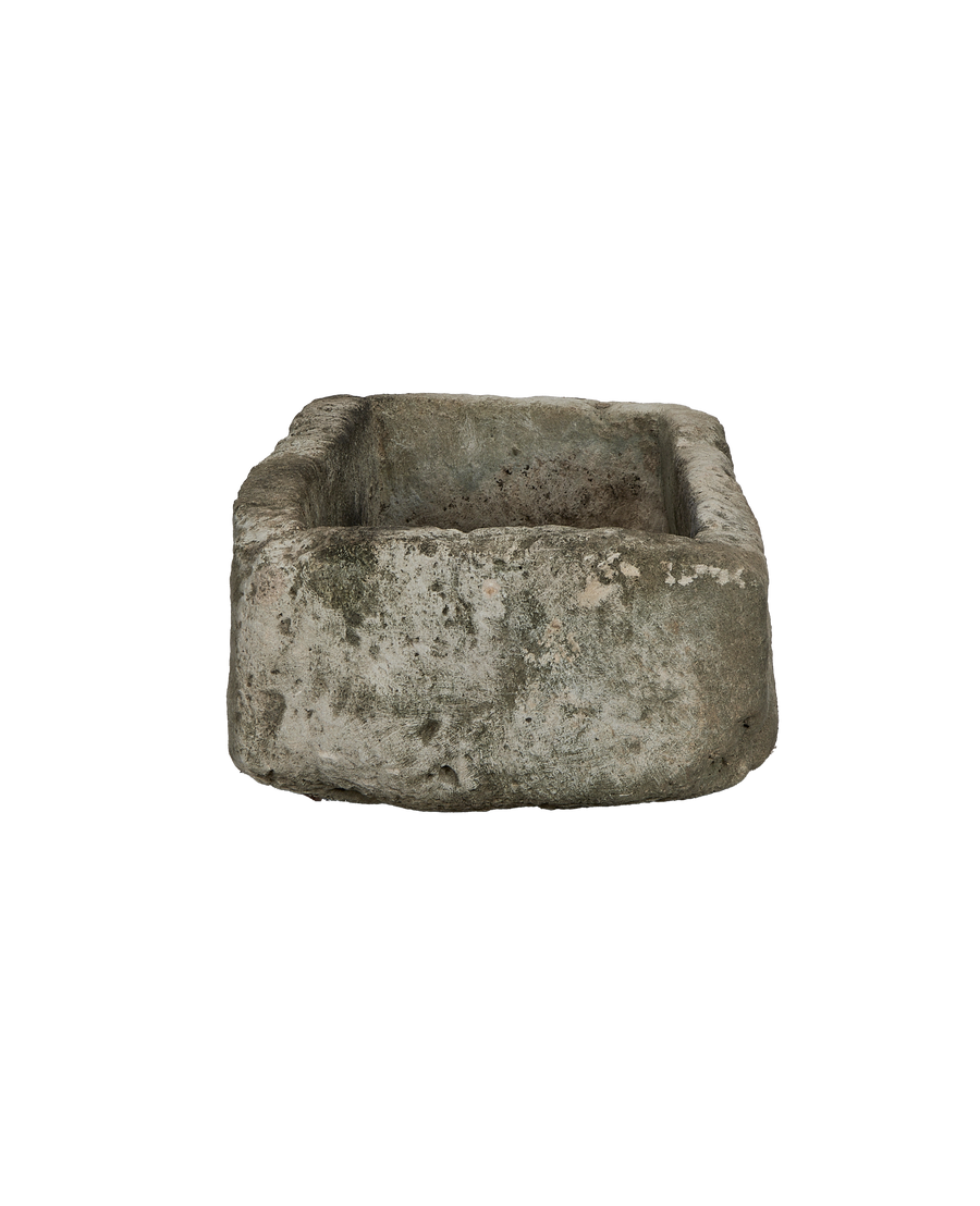 Vintage limestone trough, rectangular, showing textural weathered surface and inner basin from Indonesia.