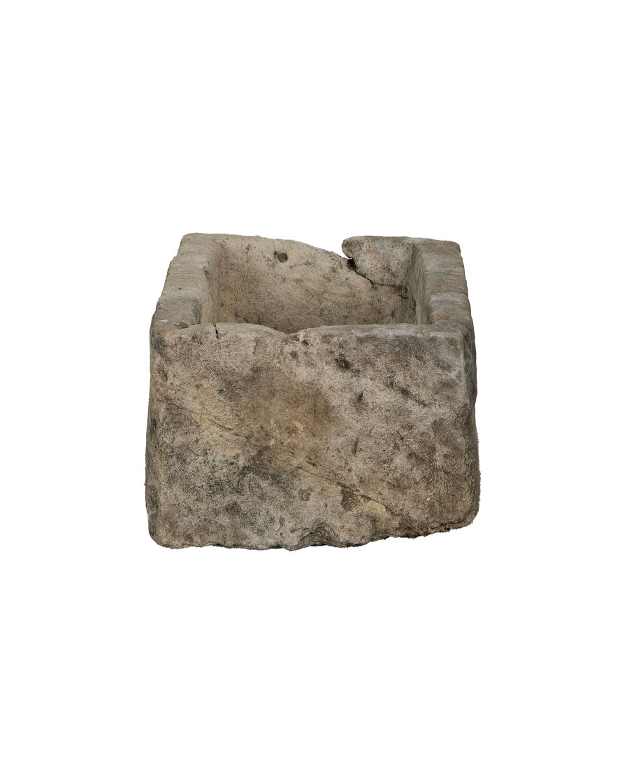 Vintage limestone trough, rectangular, showcasing chipped front edge and rustic texture.