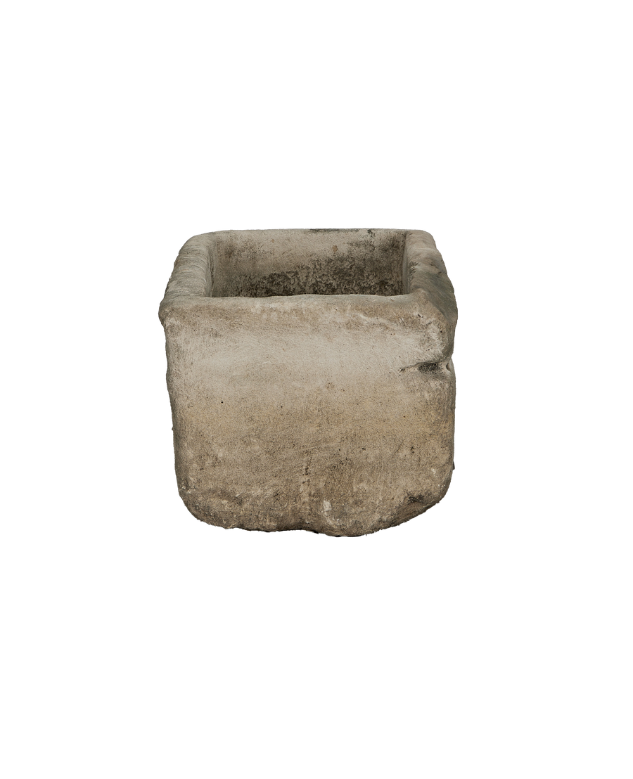 Vintage rectangular limestone trough, showing the weathered texture on its rough sides and aged interior.