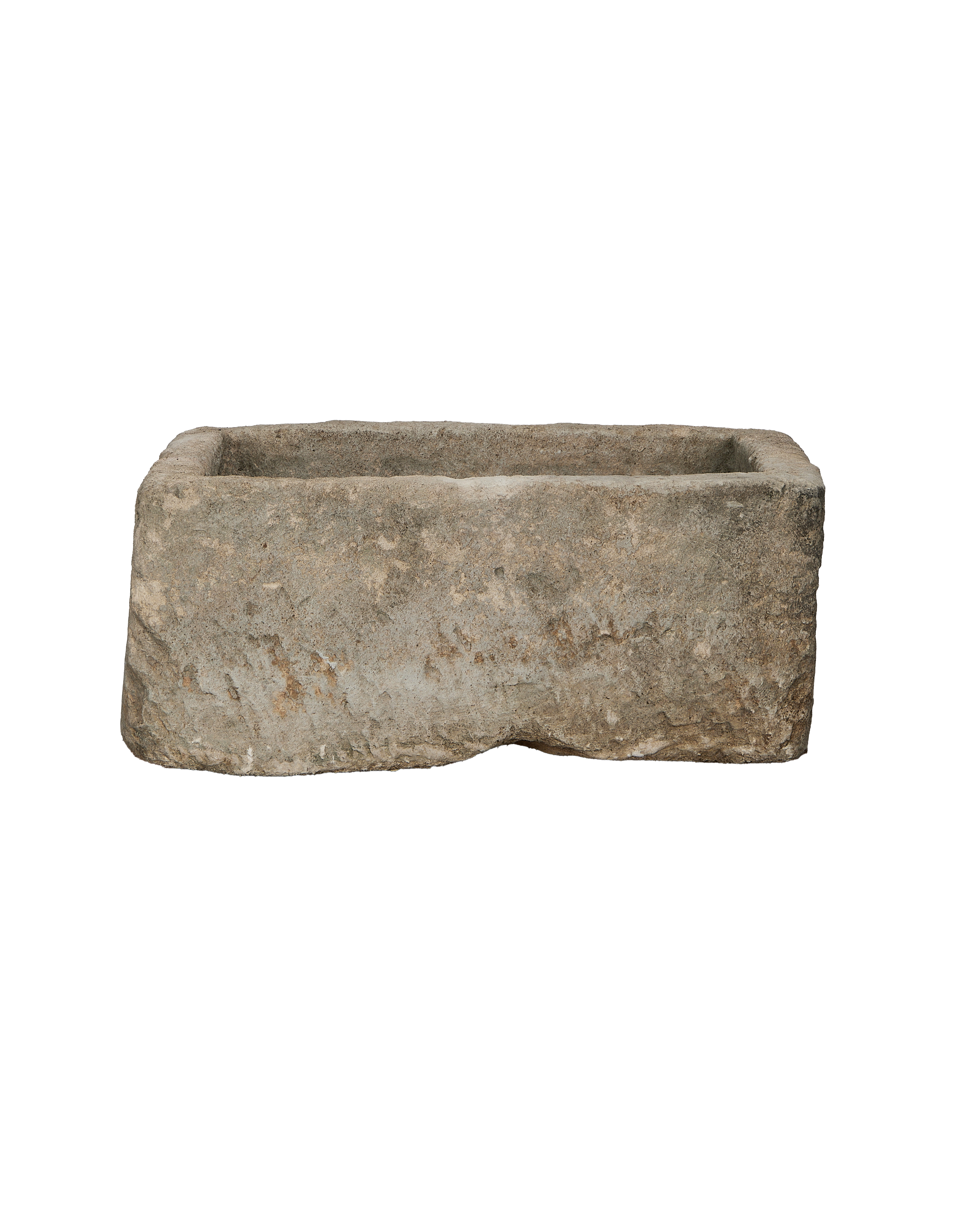 Vintage rectangular limestone trough, showing rough-hewn exterior texture and a worn surface.