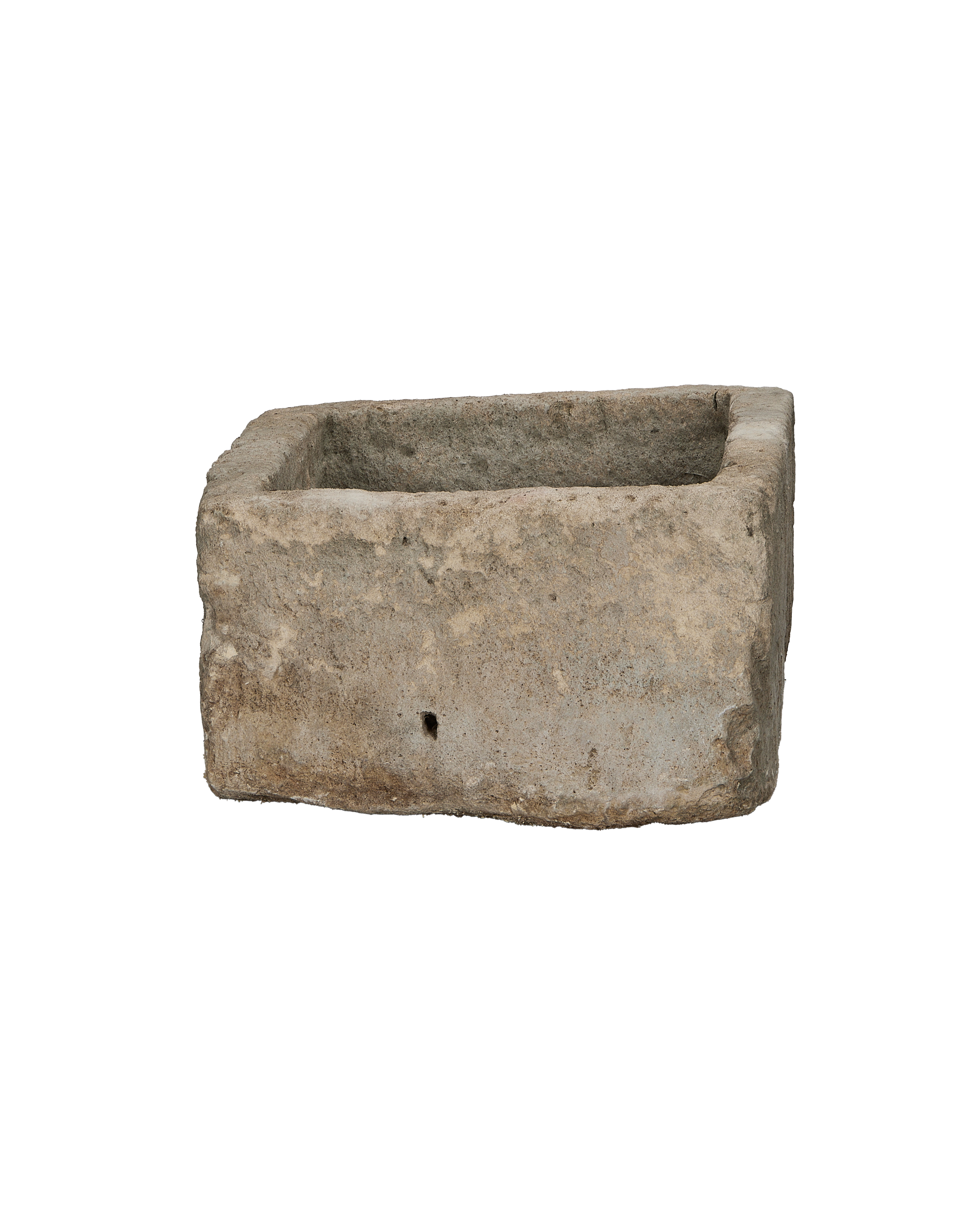 Vintage rectangular limestone trough, showing the side with a small natural drainage hole.
