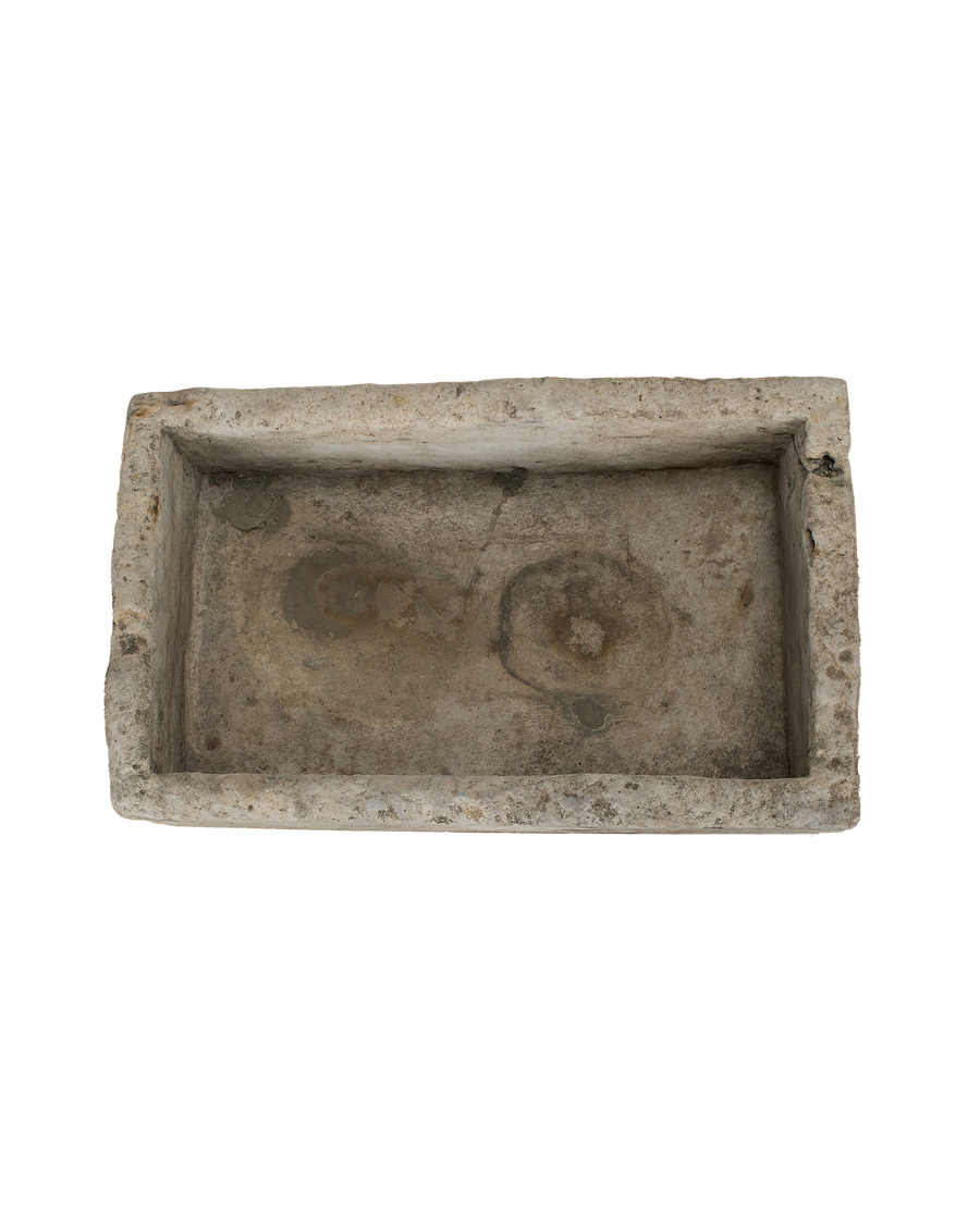 Vintage rectangle Indonesian limestone trough, showing weathered interior with original circular markings.