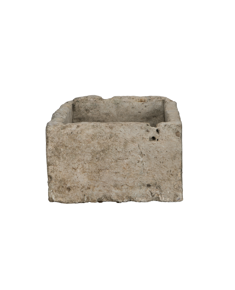 Vintage rectangular limestone trough, side view revealing rustic texture and natural imperfections.