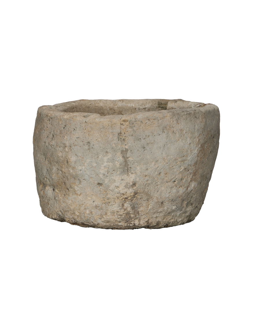 Vintage round limestone trough from Indonesia, showing rough texture and weathered finish.