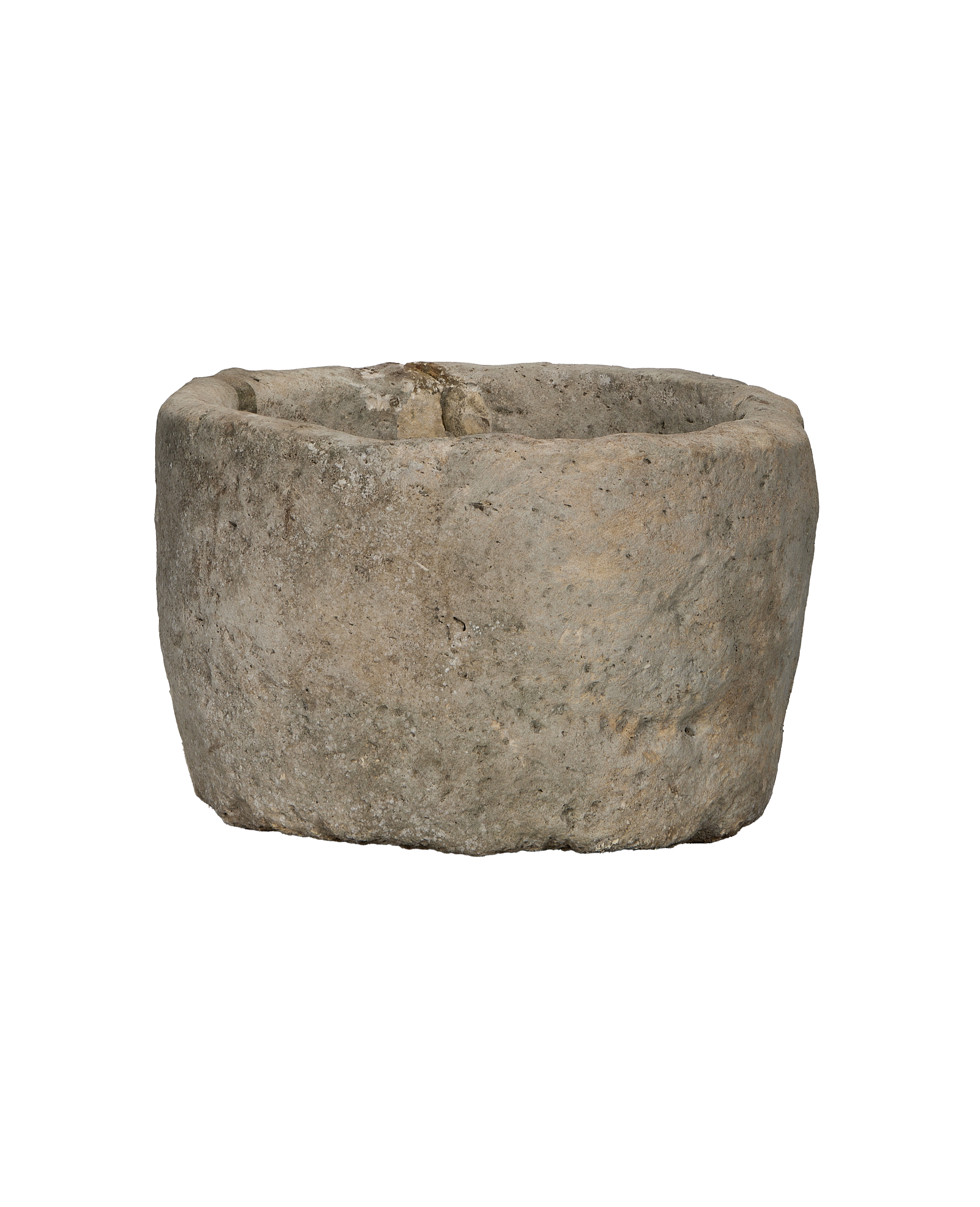 Side view of vintage round Indonesian limestone trough, showcasing textured exterior.