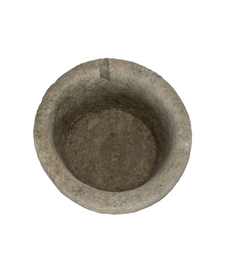 Vintage round Indonesian limestone trough, top-down view showing interior texture and depth.