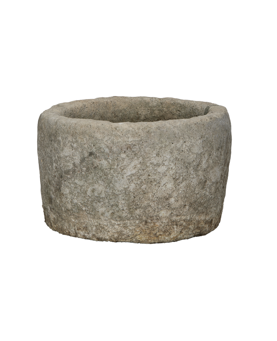 Vintage Indonesian round limestone trough, showing weathered texture and natural edge.