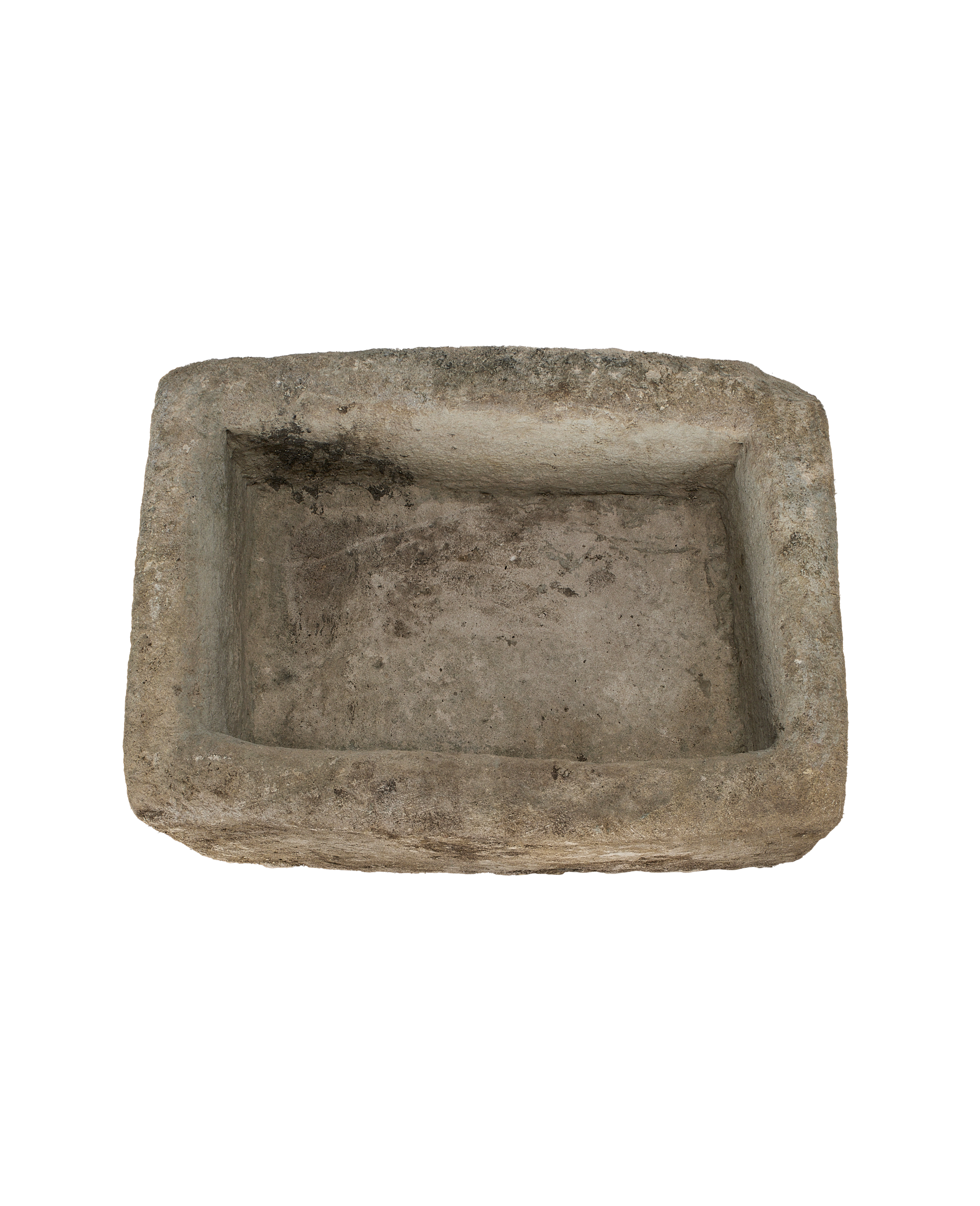 Vintage rectangular limestone trough, rustic texture, dark interior, top-down view.