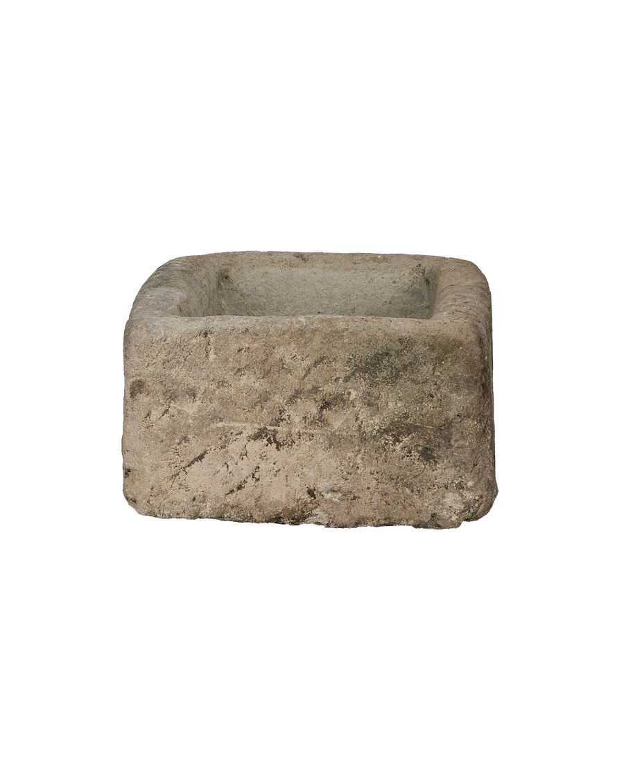 Vintage rectangular limestone trough, close-up showing rough texture and weathered finish.