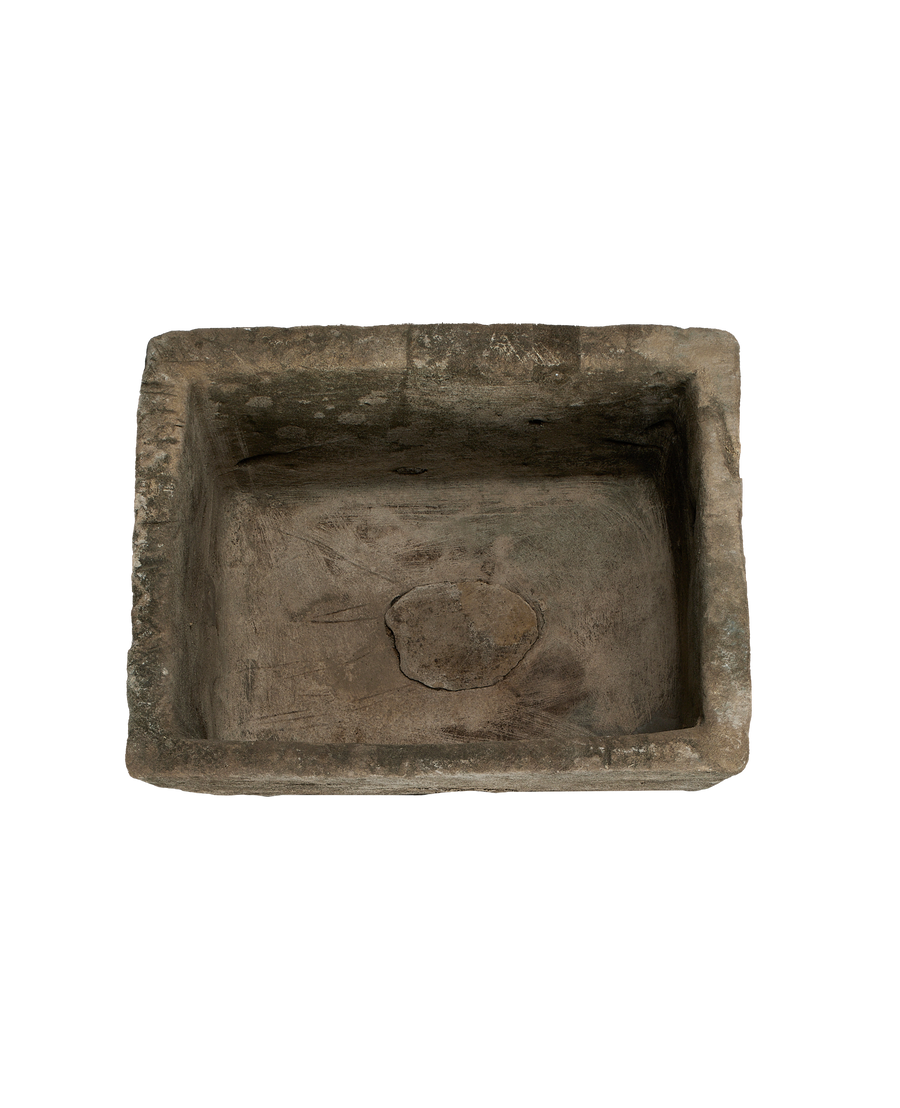 Vintage limestone trough from above, showing rectangular shape and weathered interior texture.