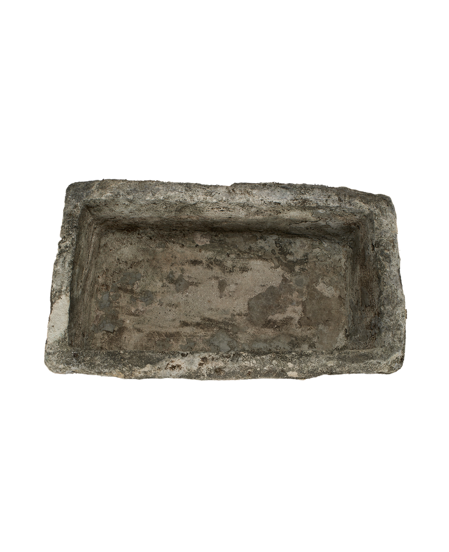 Vintage Indonesian limestone trough, top view revealing rough, weathered interior surface and rectangular shape.