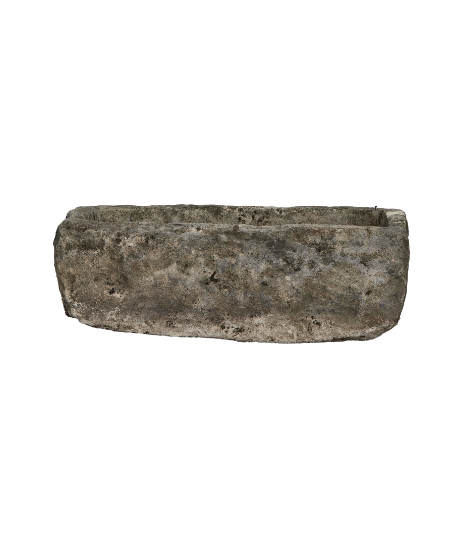 Vintage limestone trough from Indonesia, weathered surface, rectangular shape, side view.