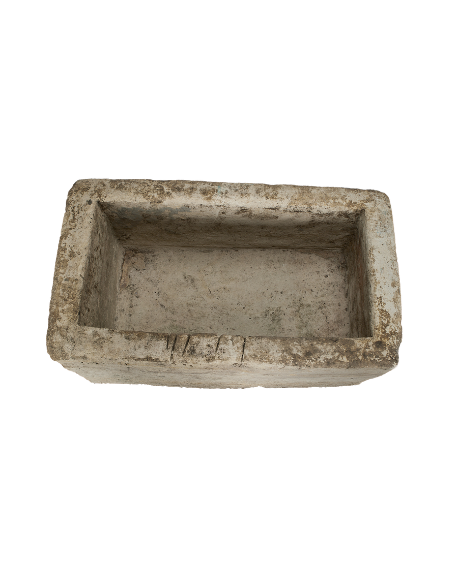 Vintage rectangular limestone trough, weathered gray surface, showing interior and textured rim details.