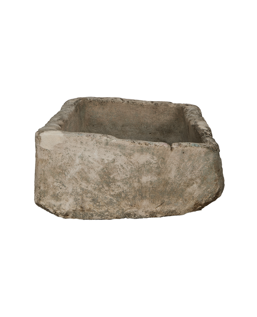 Vintage Indonesian rectangular limestone trough, showcasing weathered texture and raw edges from a side angle.