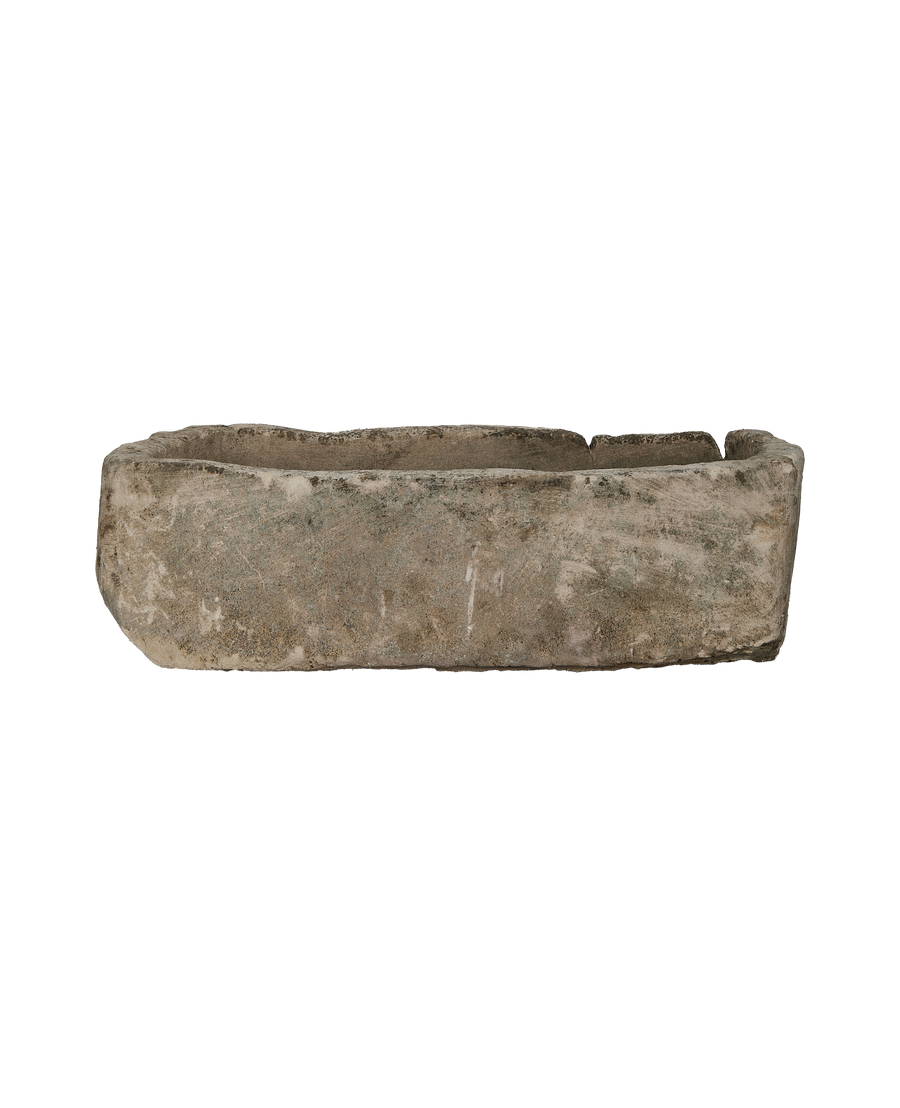 Vintage Indonesian limestone trough, rectangular, rough-hewn texture, and worn condition, side view.