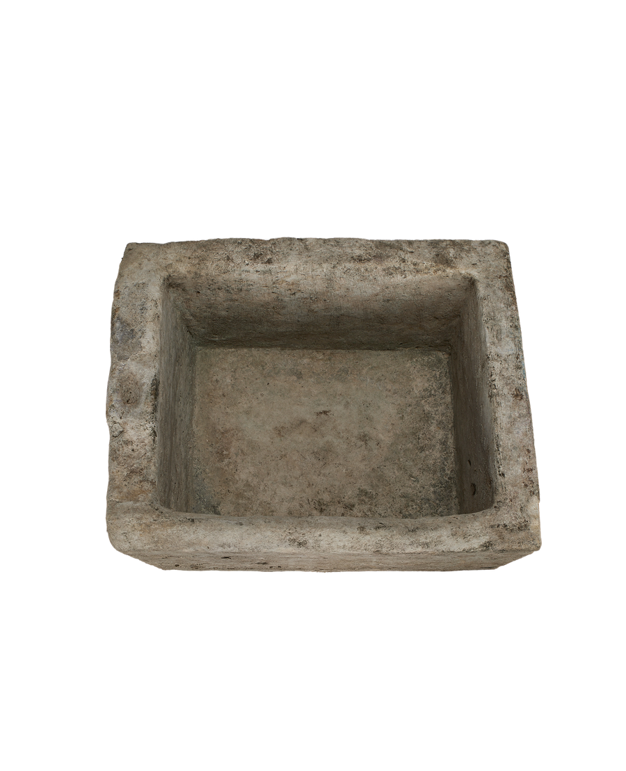 Vintage rectangular limestone trough, showing the weathered texture inside with rough, uneven edges.
