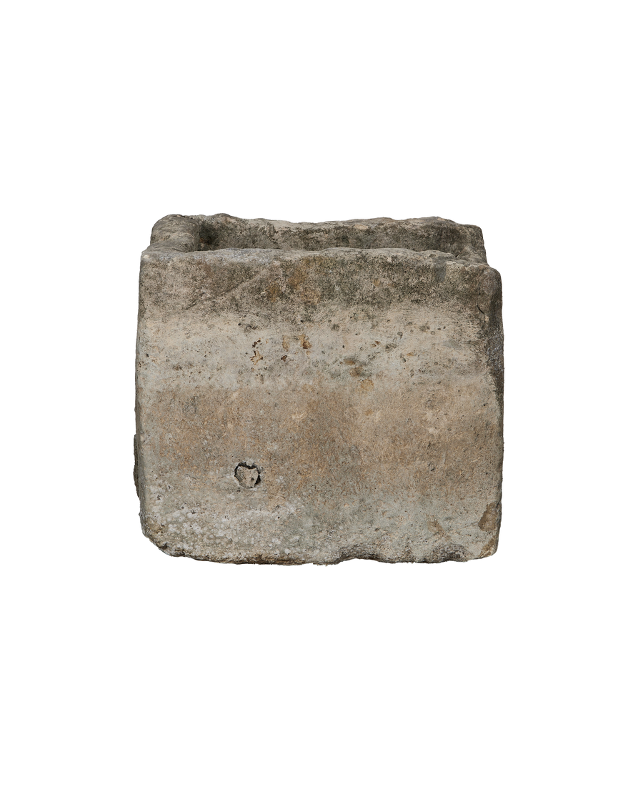 Vintage rectangular limestone trough, side detail showing textured surface and carved hole.