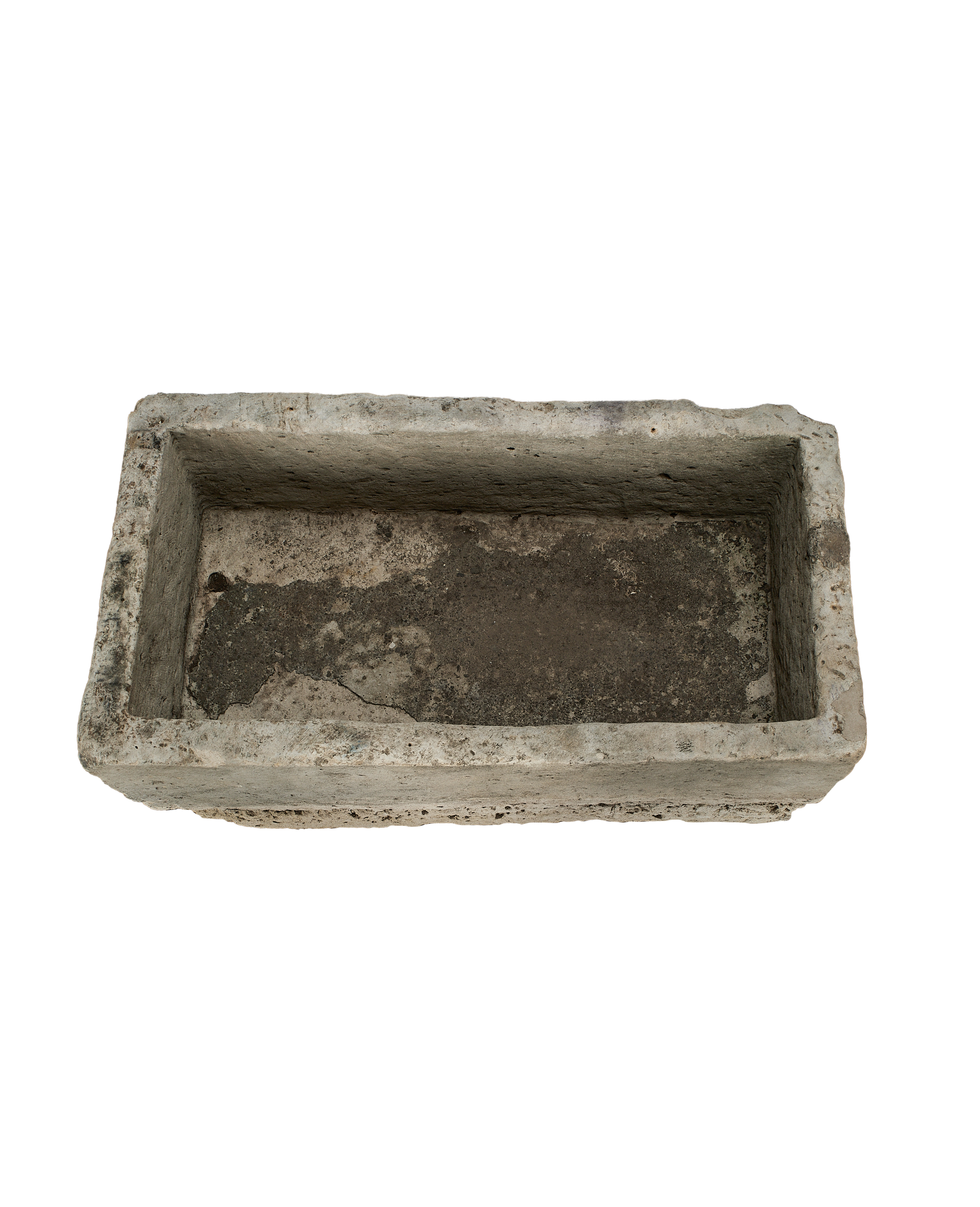 Vintage Indonesian limestone trough viewed from inside, showing distressed texture and weathered dark bottom.