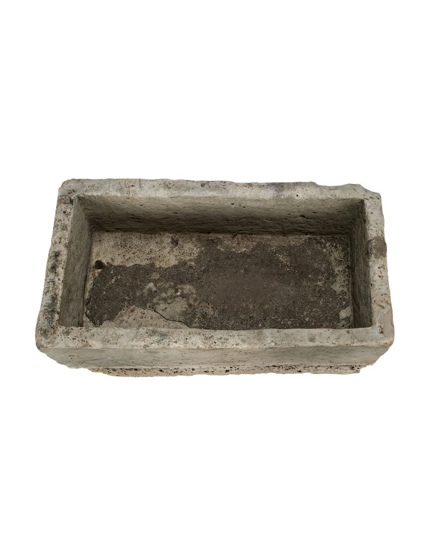 Vintage Indonesian limestone trough viewed from inside, showing distressed texture and weathered dark bottom.