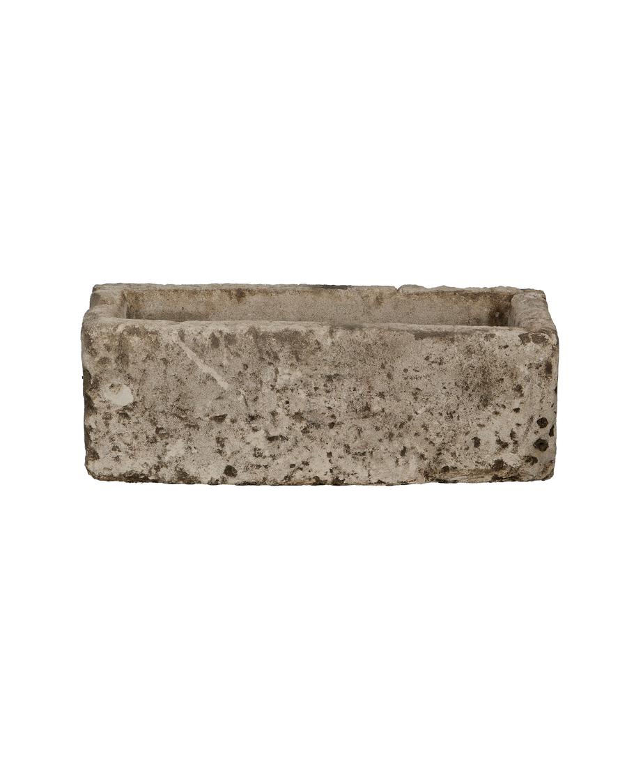 Vintage rectangular Indonesian limestone trough, showing detail of aged texture and dark patina.